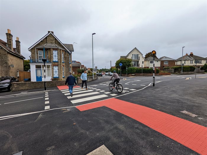 people using pedestrial crossing on Garland Road