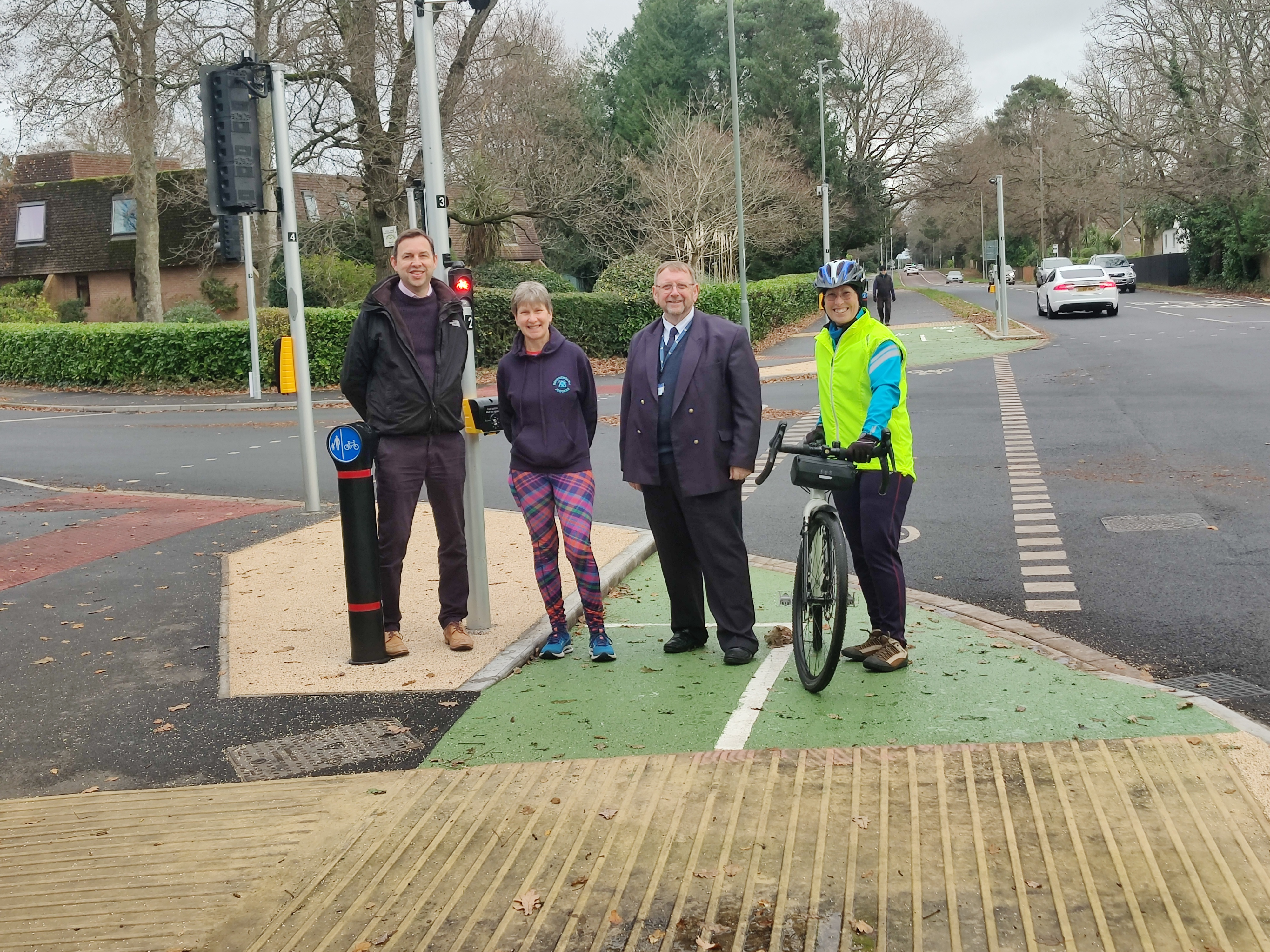 Four people stood at a toucan crossing